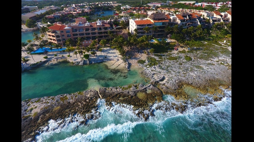 Top view of ocean rock coastal and residential buildings at Casacun Puerto Aventuras