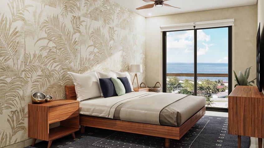 Bedroom with ocean view window at Porto Blu Puerto Morelos