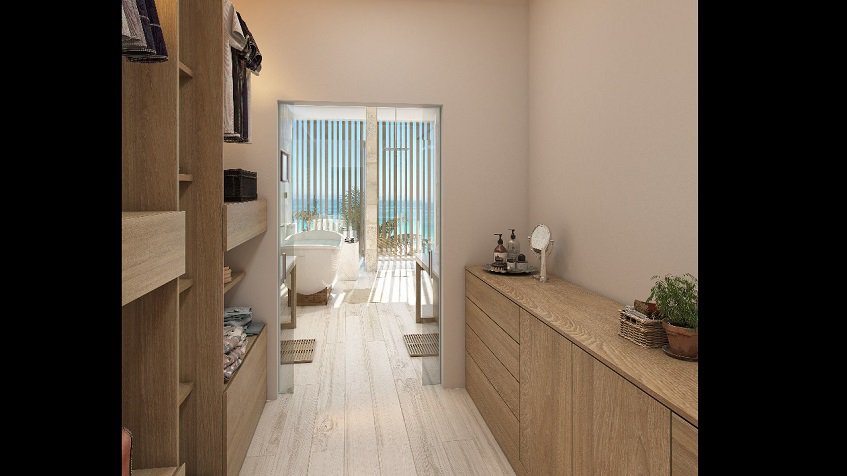 Walk in closet and a bathtub in front of the ocean view window at Casacun Puerto Aventuras