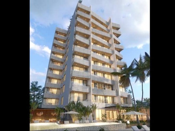 Tall nine level residential building surrounded by vegetation at Distrito Puerto
