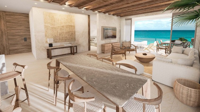 Living room with a large table and the other on an ocean view terrace at Kaoba Tulum