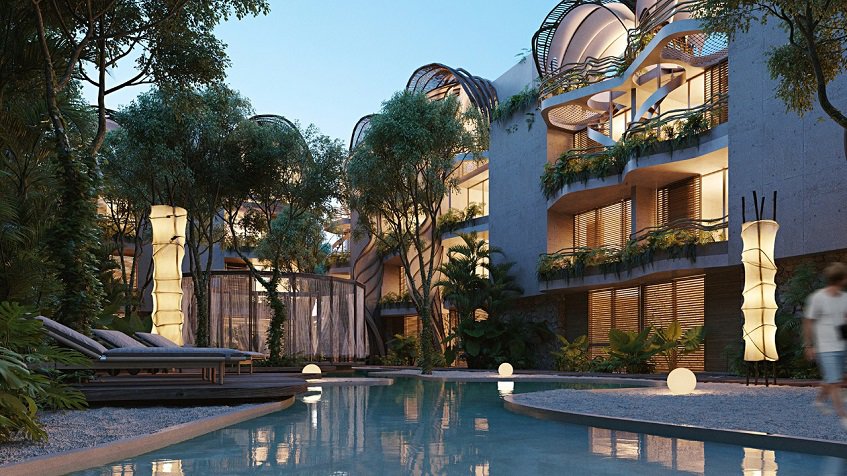 Residential Building facade with balconies and pool after sunset at Selva Ambar Tulum