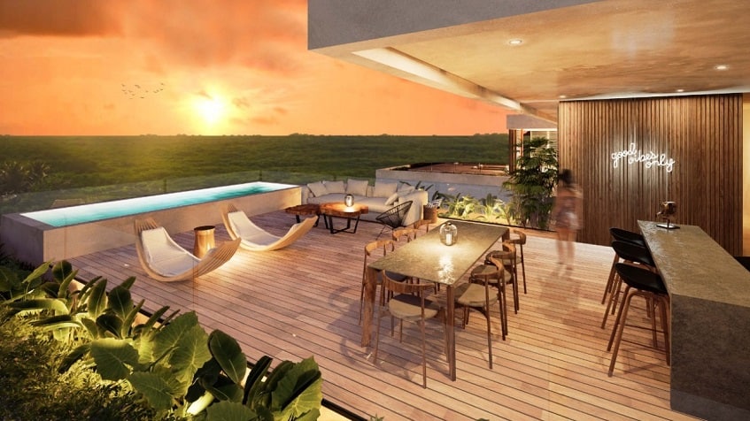 Large terrace with long pool, large table and bar at Kaoba Tulum