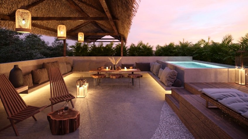 Rooftop garden with a pool and lounge area after sunset at Homa Kah Tulum