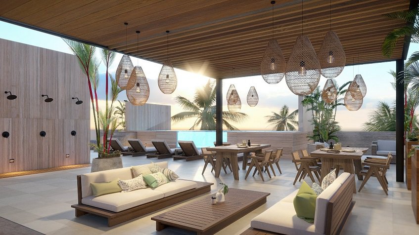 Rooftop social area with sofas and dining tables, pool at Distrito Puerto