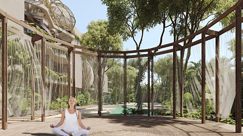 Yoga space within wooden construction and transparent courtines, woman meditating at Selva Ambar Tulum
