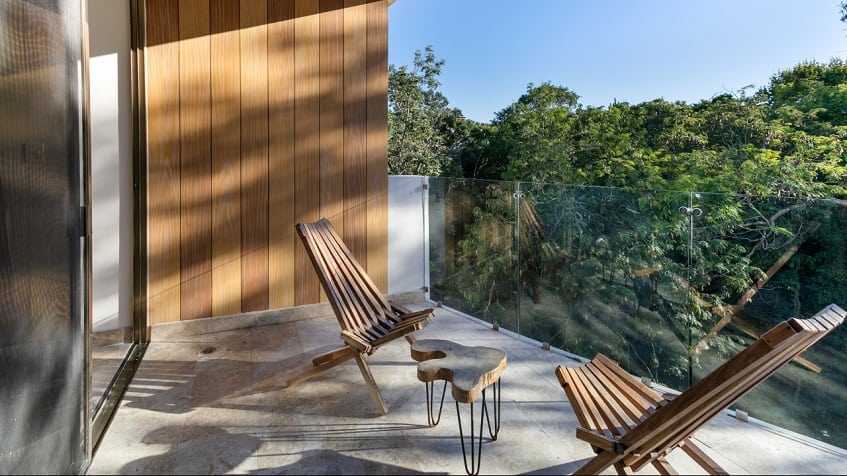 Terrace with two chairs and table, jungle view at Gaia Residence