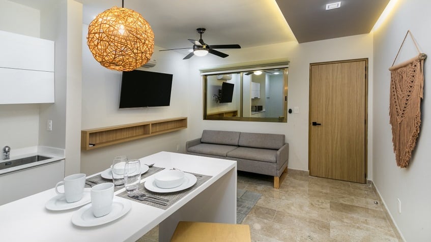 Kitchen with a breakfast bar set for two, sofa at Gaia Residence