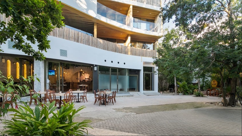 Residential building facade with open dining area, balconies at Gaia Residence