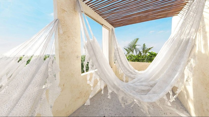 White hammocks with a jungle view at Caribique Playa del Carmen