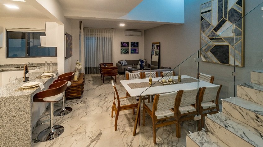 Living room, staircase, dining table next to the breakfast bar at Crozet House | Bali at Riviera Maya