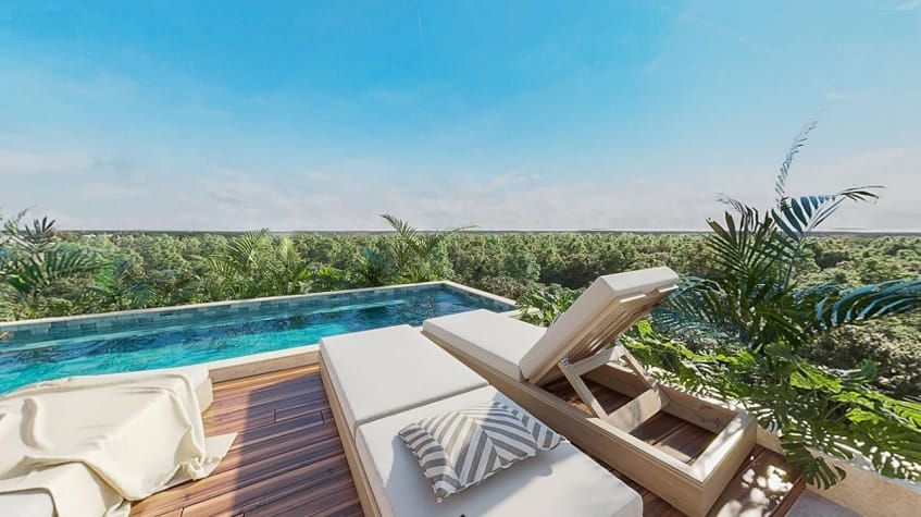Pool rooftop, sunbeds and jungle view at Caribique Playa del Carmen