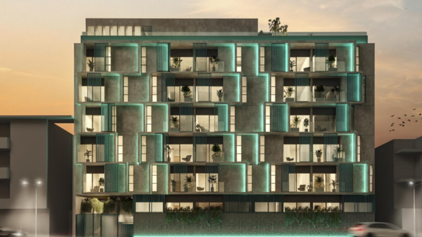 Residential building facade with green illumination at Altra Beach Condos
