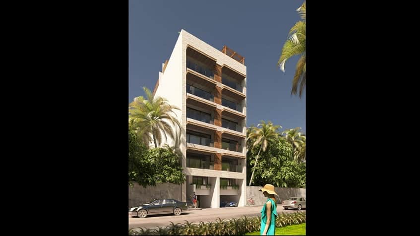 White residential building, a woman in a reen dress and cars passing by at Blanko 54 Playa del Carmen