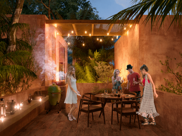Terrace and three women and a men next to a grill,dining table, chairs, vegetation at Tulix Tulum