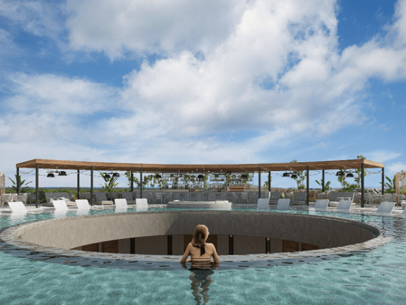 Rooftop pool in a circle shape whole in the middle and woman inside a water watching someting at Tuk Origen Tulum