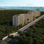 Aerial view of residential tall building surrounded by the jungle, ocean in the background at Okun Living Cancun