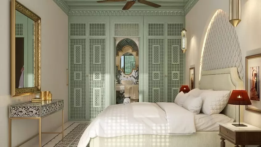 Bedroom with a bed in front of a mirror, arabic style closet and door to a bathroom at Pink Riad Tulum