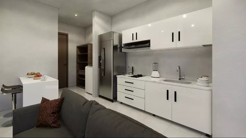 White kitchen with a breakfast bar, dark sofa at Sur 307 Condominios