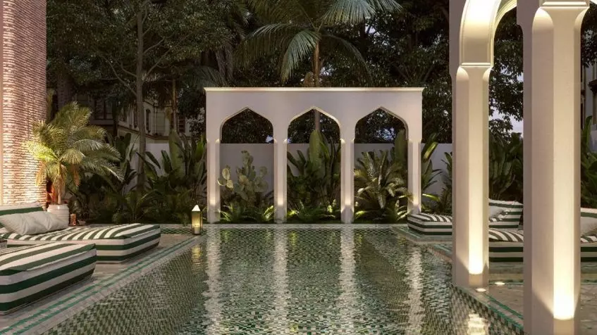 Pool, sunbeds and arabic style arcades structures at Pink Riad Tulum