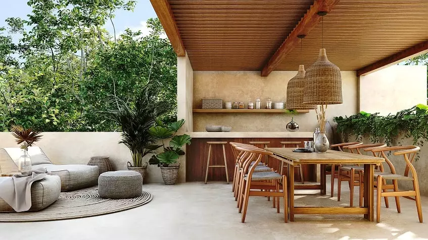 Large terrace with a dining table set for six and bar at Retiro Tulum Artisan Homes