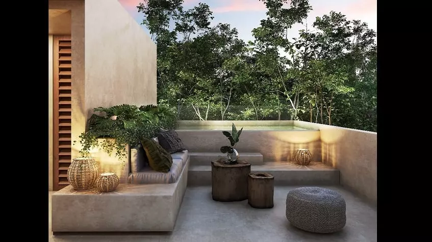 Pool terrace with a build in pool surrounded by vegetation at Retiro Tulum Artisan Homes