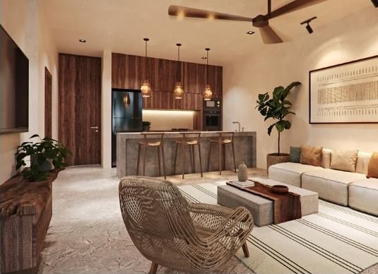 Living room and kitchen with breakfast bar at Kukun Tulum Condos