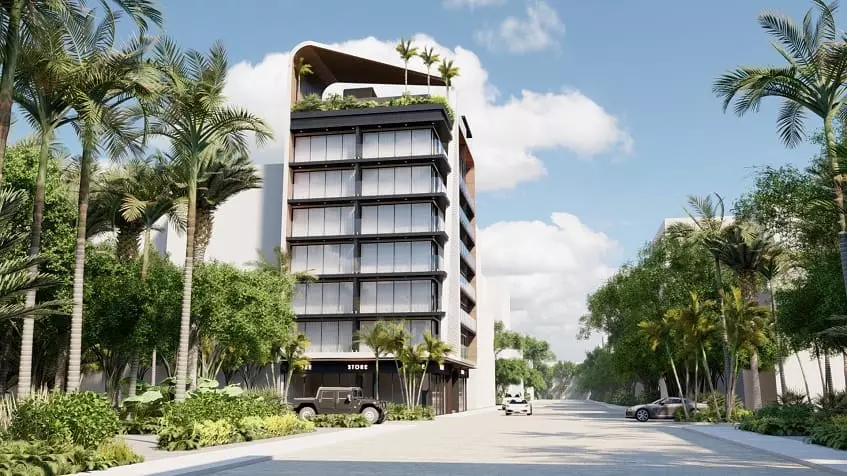 Residential building and cars passing on the street at Alizee Tower Playa del Carmen