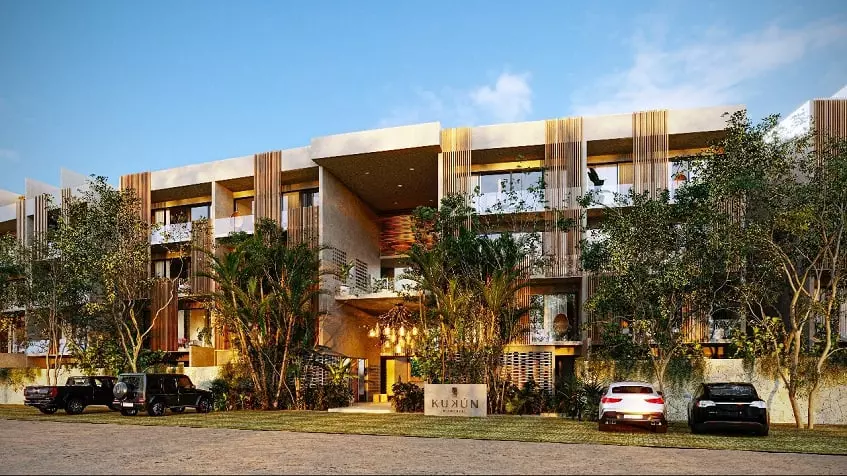 Residential building fachada with a parking in front at Kukun Tulum Condos