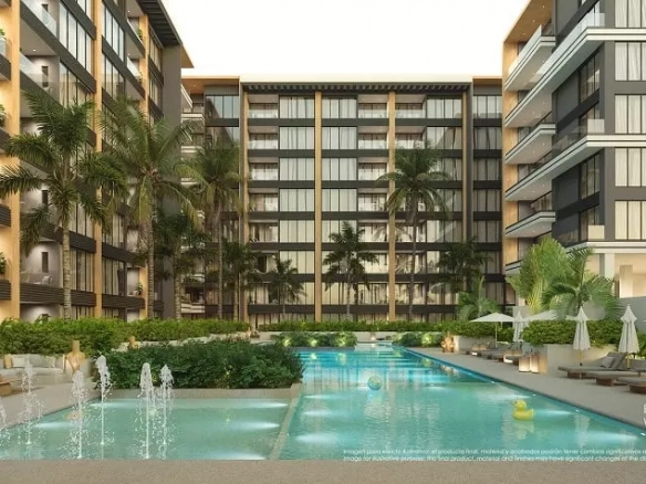 Splash pool and pool surrounded by umbrellas, sunbeds and palm trees, residential building at Origin by Wolf Cancun
