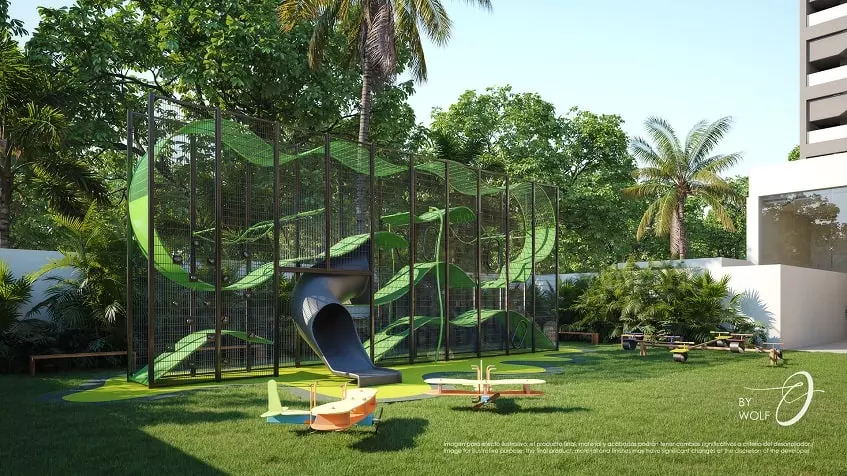 Kids playground structure with slides and green area at Origin by Wolf Cancun