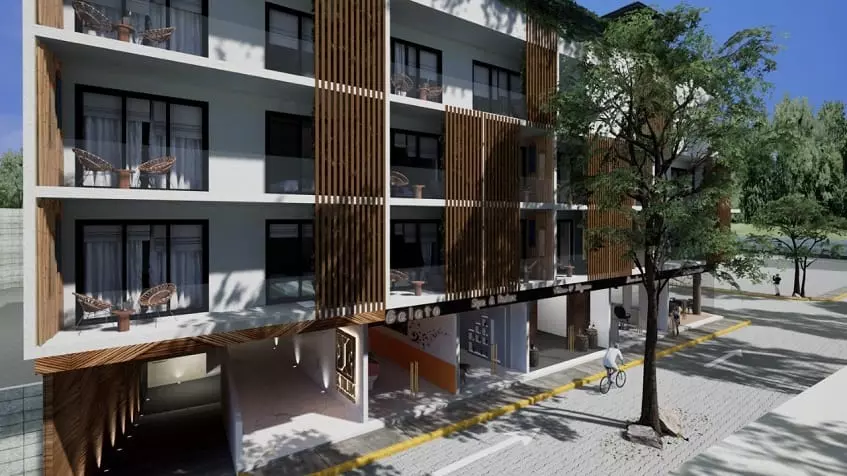 Residential Building with balconies and small table,two chairs on each at Ix Tulum Apartments