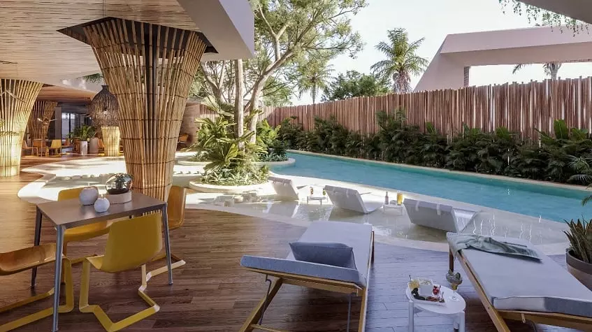 Pool area with sunbeds and dining table at Kolmena Playa del Carmen