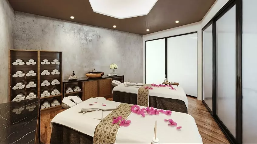 Spa room with two massage beds with pink flowers on top at Kolmena Playa del Carmen