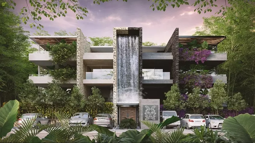 Residential building facade with a waterfall and cars parked in front, surrounded by a jungle at Xexen y Xakah