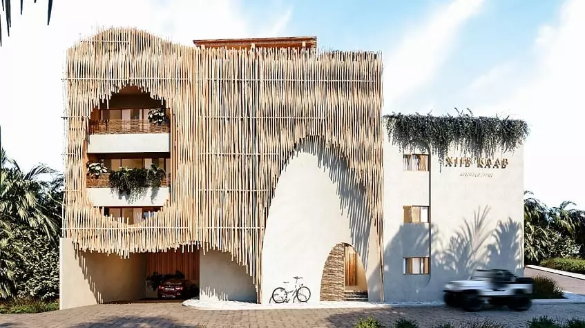Residential building front facade with a bamboo decoration, bicycle and car parking at Xiib Kaab Tulum