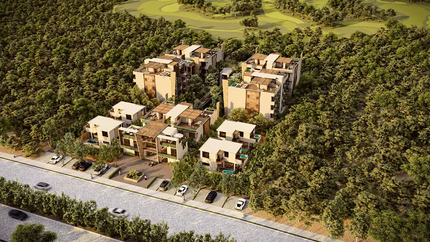 Aerial view of a residential buildings with parking in front, surrounded by jungle at Baikal Tulum Country Club