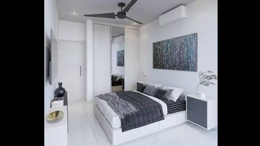 White bedroom with a bed next to a closet at Ocean Life Playa del Carmen