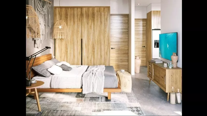 Bedroom with a bed next to a closet and TV screen at Torre 48 Playa del Carmen