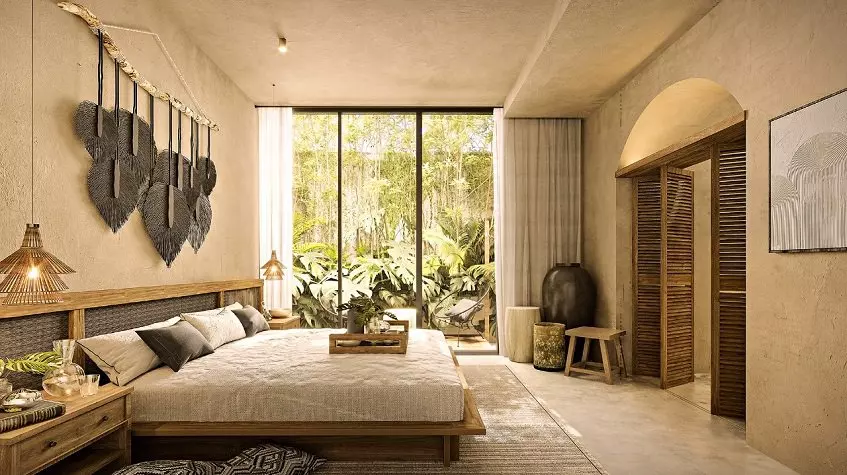 King size bed in front of the folding door, large window and garden view at Satori Tulum