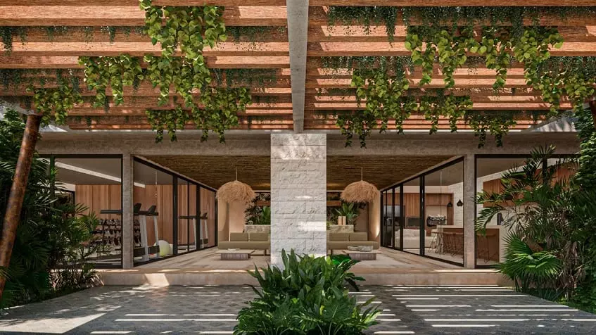 Open lobby entrance with lounges and glass doors with a Gym and other common area at Nuup Tulum Region 8