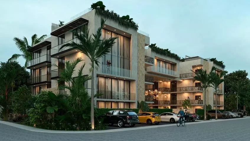 Residential building facade with large windows and parking area and man on a bicycle at Xama Tulum