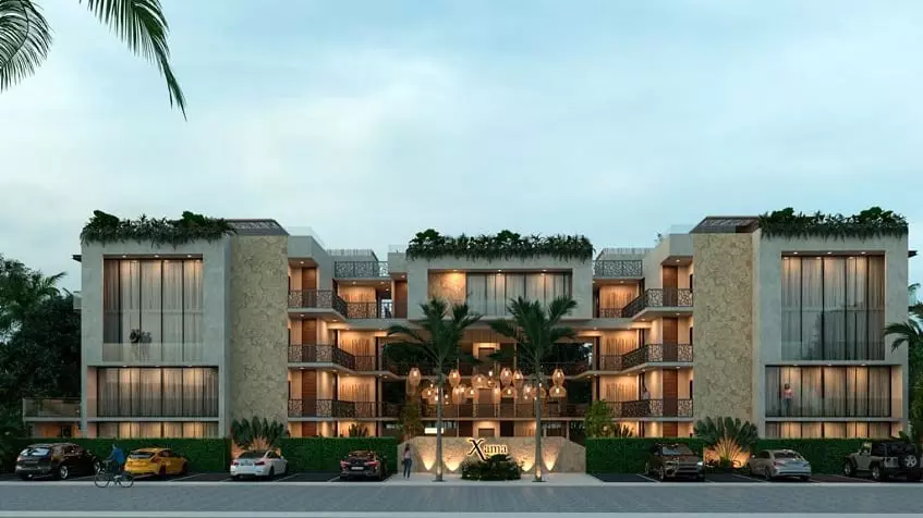 Residential building facade with large windows and parking area at Xama Tulum