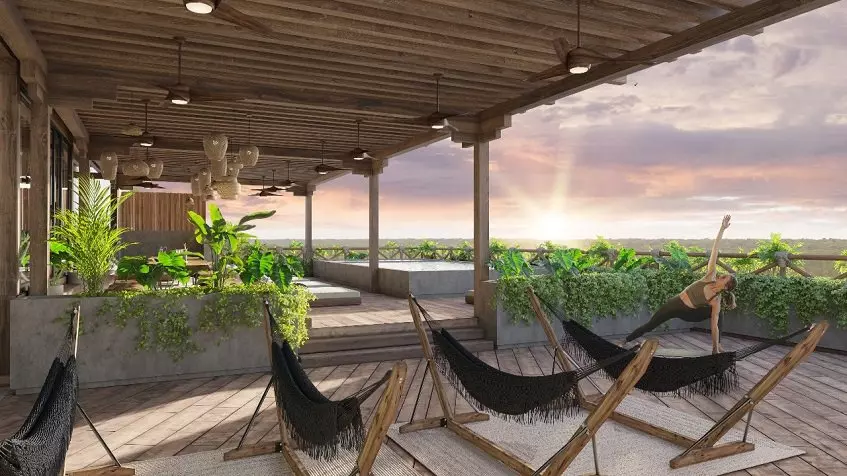 Hammocks terrace with a pool, a woman doing exercise at Acalai Beach Tulum