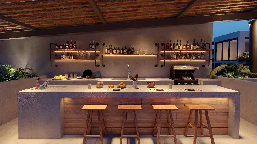 Large bar, kitchen behind it with a grill at Kateen Tulum