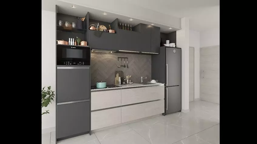 Kitchen with black and white furniture, fridge and electric stove at Ocean Life Playa del Carmen