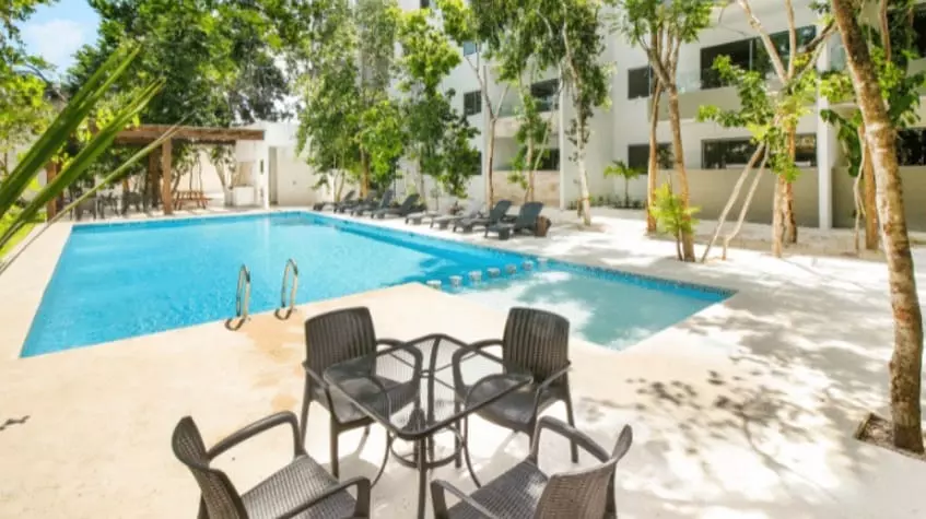 Swimming pool with a kids pool and a garden table, residential building at Selvanova Playa del Carmen