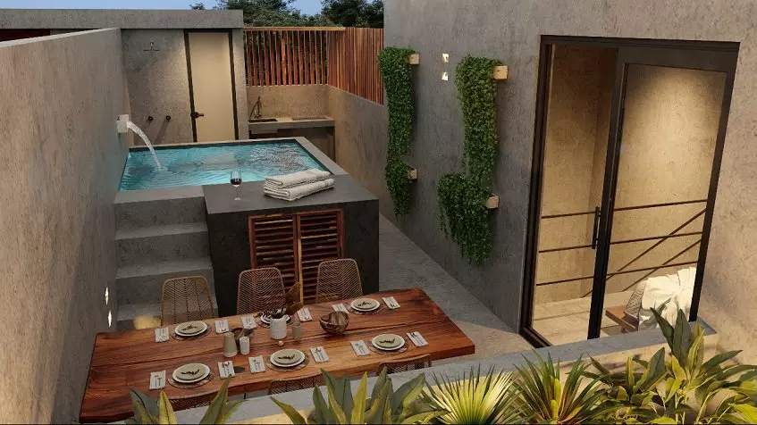 Rooftop area with a pool and dining table at Kateen Tulum