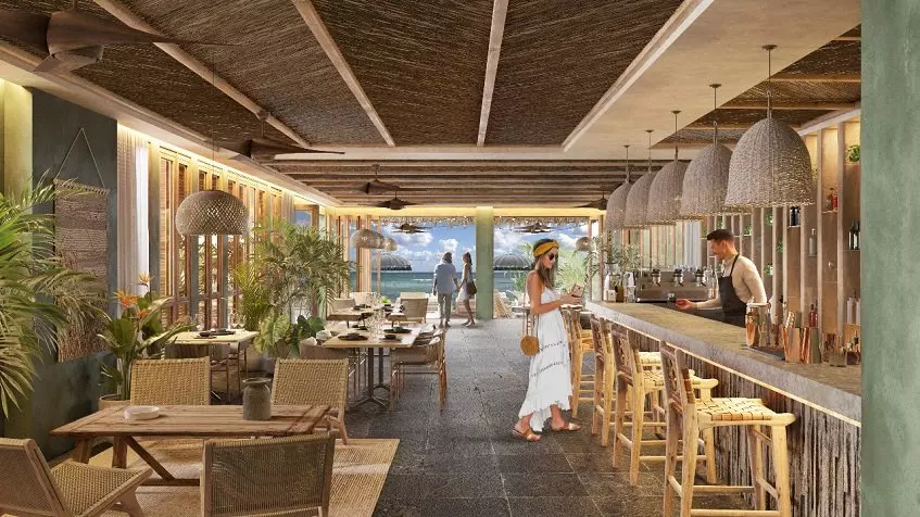 Restaurant bar and a woman pain to a bartender, oceanview at Acalai Beach Tulum