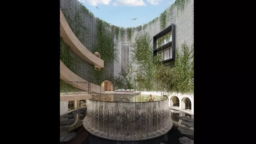 Pool with a waterfall, a woman inside a water, residential building facade at Oniric Tulum